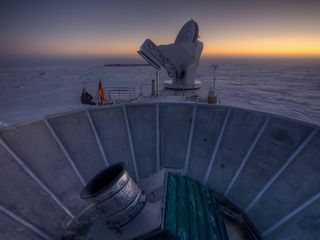 The sun sets behind BICEP2 (in the foreground) and the South Pole Telescope (in the background) in this stunning space wallpaper.