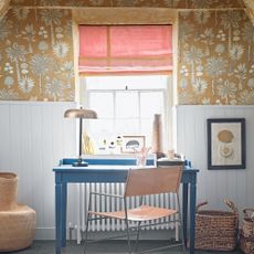 White wall panel with yellow wallpaper and a blue desk