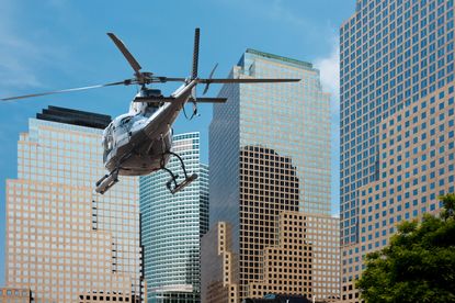 A helicopter flies through Manhattan's Financial District.