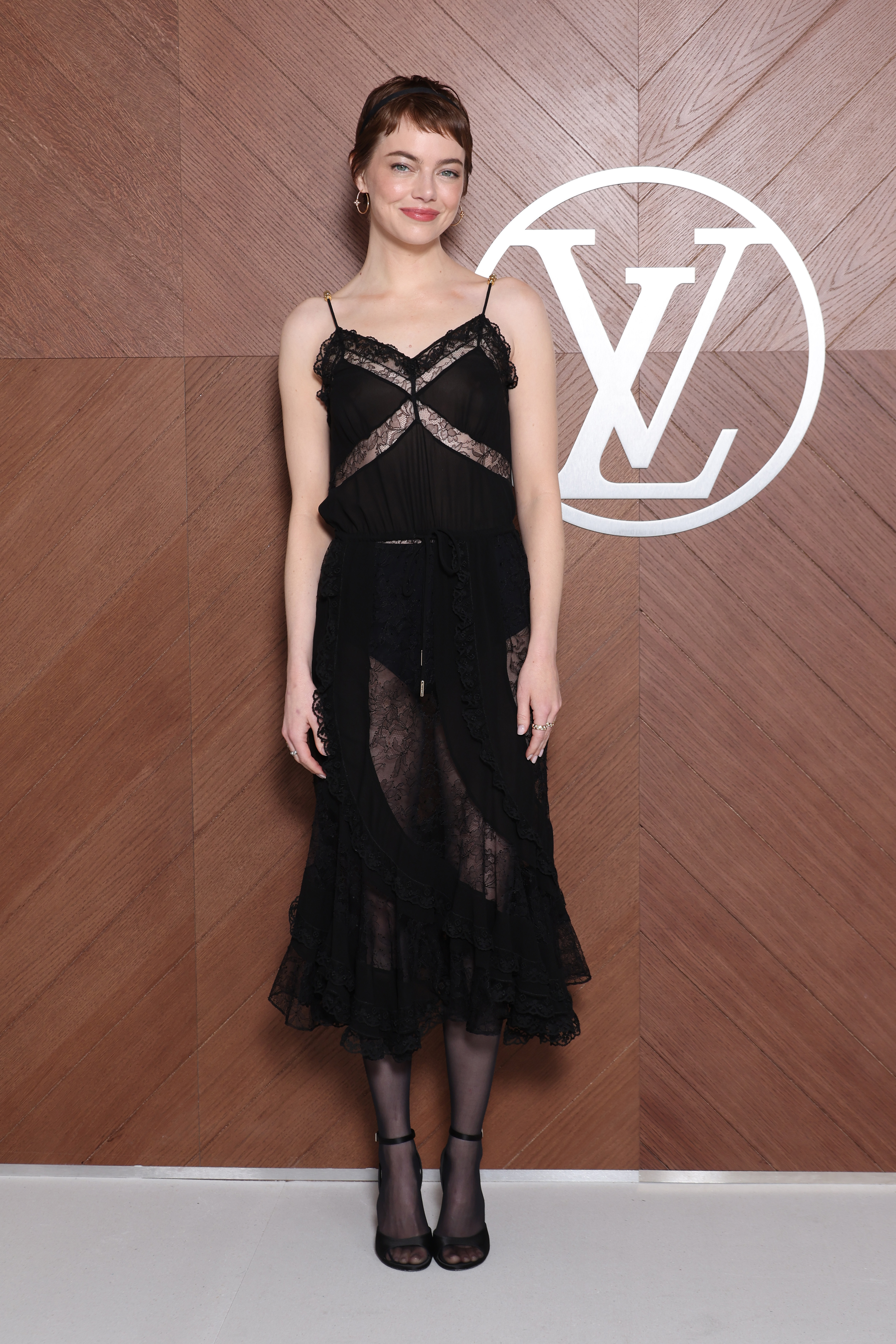 Emma Stone attended a Louis Vuitton show in a lacy LBD