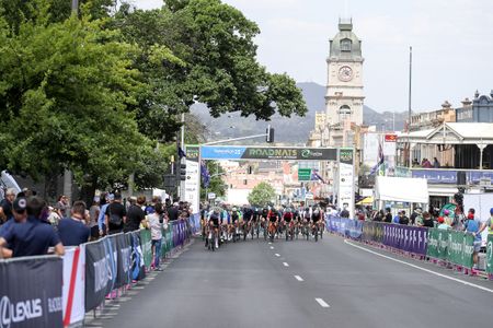The peloton passes under the start/finish