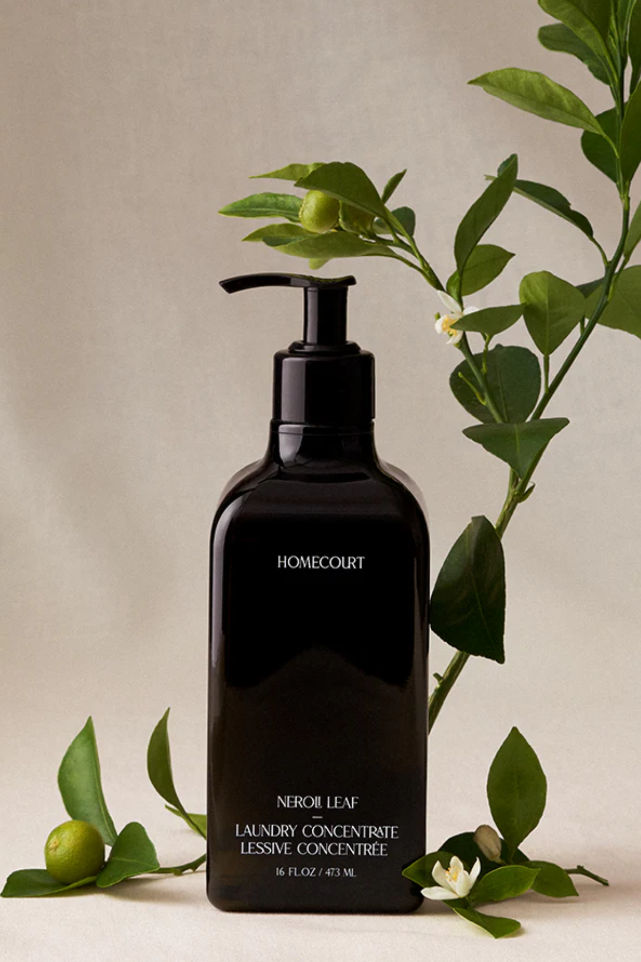 A bottle of laundry concentrate with a lemon twig