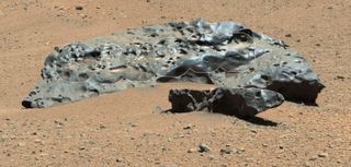 An unusual rock spotted by NASA's Curiosity rover appears to be a meteorite. Much smaller meteorites may be seeding the Red Planet’s atmosphere to allow wispy clouds to form.