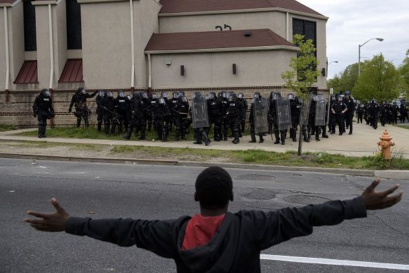 Six Baltimore police officers were fired after the government condemned the department for racial discrimination in a federal report. 