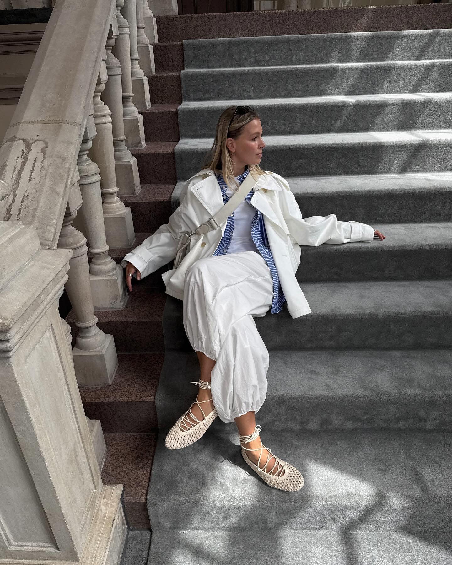 An image of @holliemercedes wearing a windbreaker with balloon pants and lace-up ballet flats, one of the best lace-up flats.