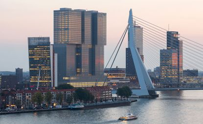 Overlooking Rotterdam's new cityscape, De Rotterdam, featuring several high-rise towers and a bridge tower. 