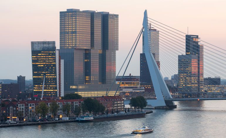 Overlooking Rotterdam&#039;s new cityscape, De Rotterdam, featuring several high-rise towers and a bridge tower. 