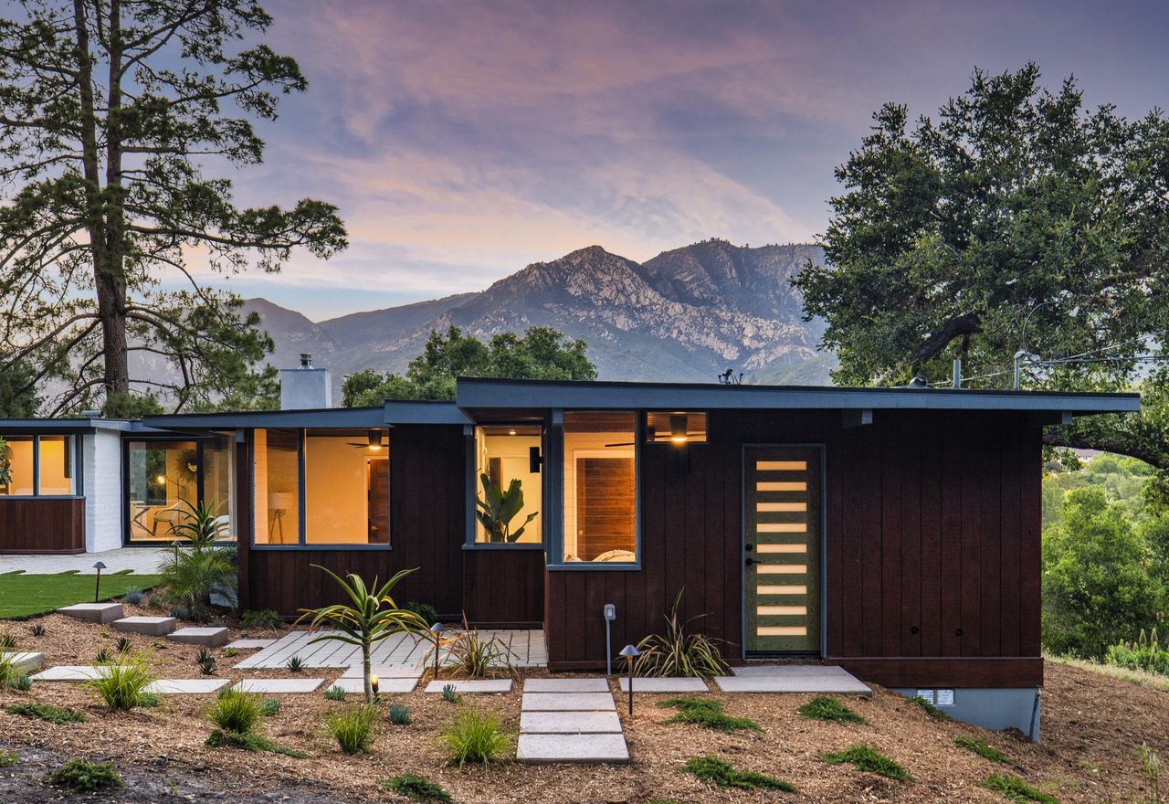 The exterior of a cabin bungalow at dusk