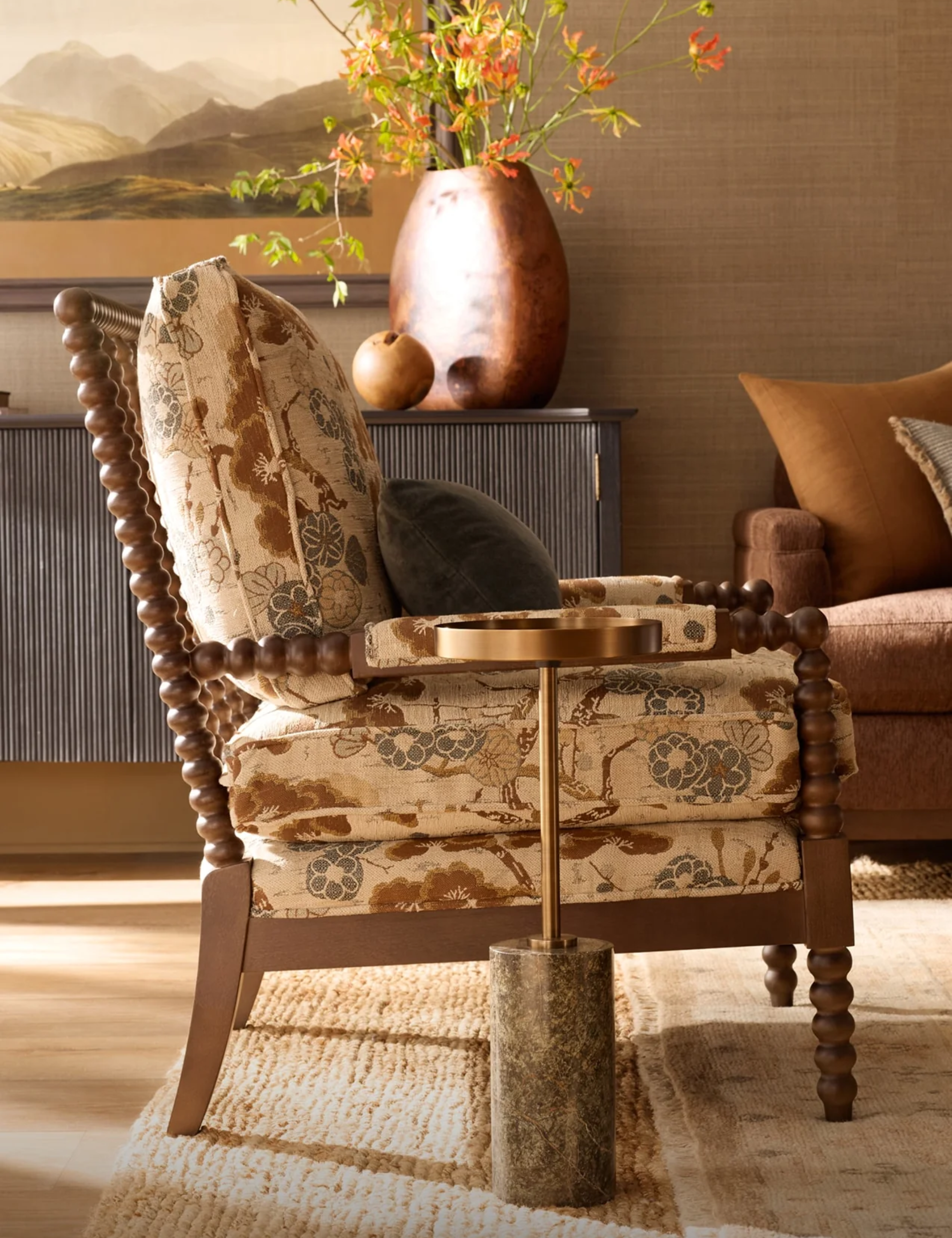 Cheerful living room styled with a tapestry-print armchair and a marble-and-metal martini table