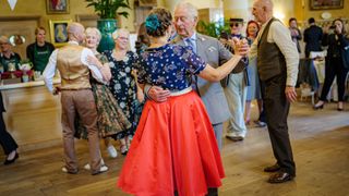 King Charles dances with Bridget Tibbs during a Jubilee tea dance hosted by The Prince's Foundation
