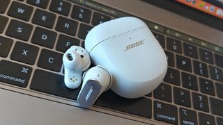 Bose QuietComfort Ultra Earbuds on a keyboard