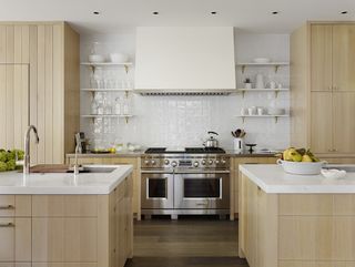 kitchen with two islands, both made from wood cabinets with white counters