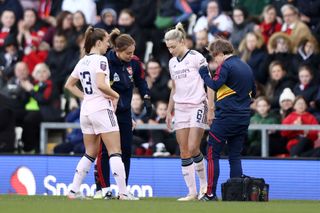 Leah Williamson of Arsenal receives medical treatment during the FA Women's Super League match between Manchester United and Arsenal at Leigh Sports Village on April 19, 2023 in Leigh, England. (Photo by Naomi Baker/Getty Images)
