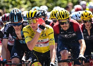2022 Tour de France leader Tadej Pogačar douses himself with water during a hot stage 10
