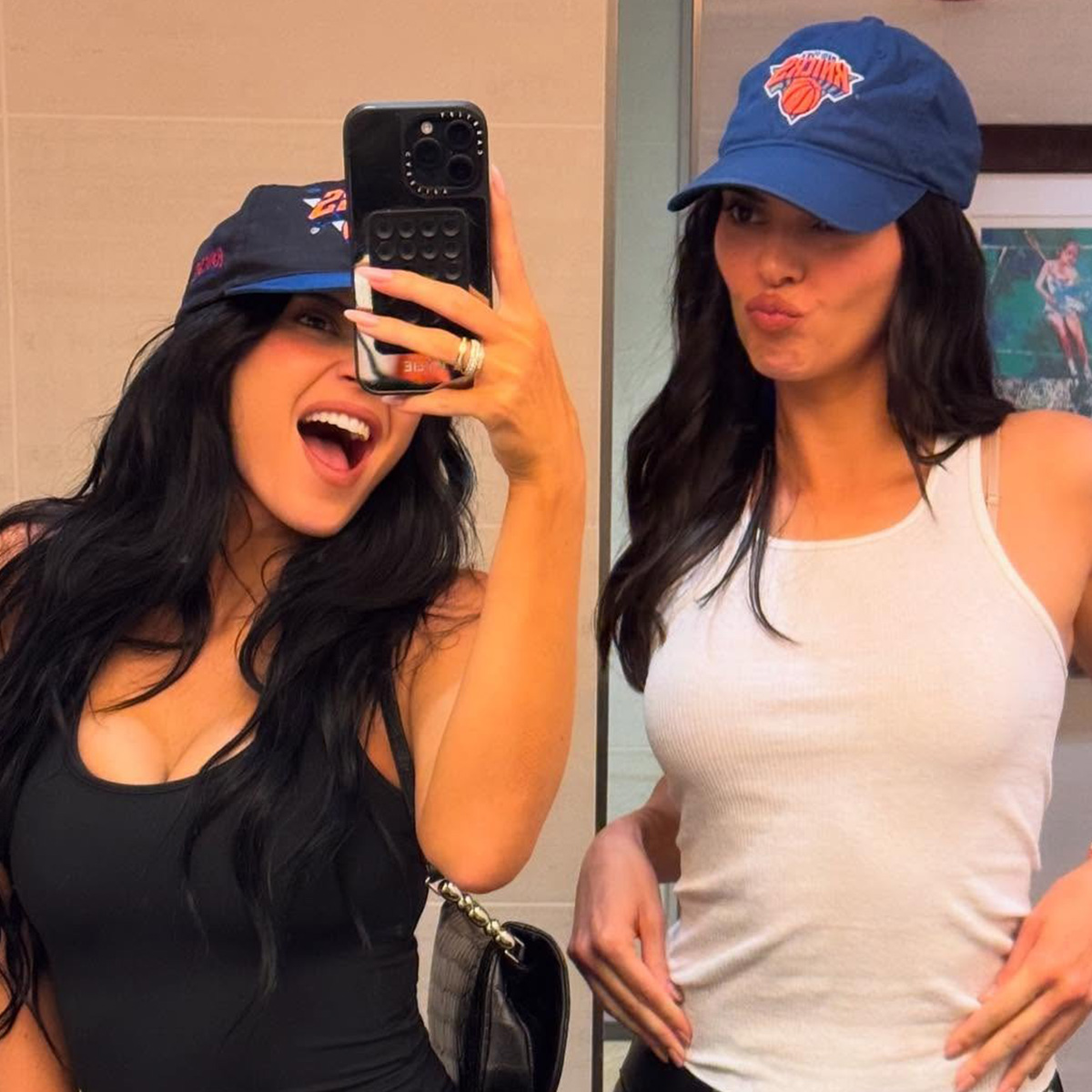 Kylie jenner wears a knicks hat and black tank top. Kendall jenner wears a knicks hat and white tank top.