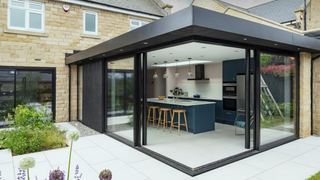 Glass box extension in the back garden of a house