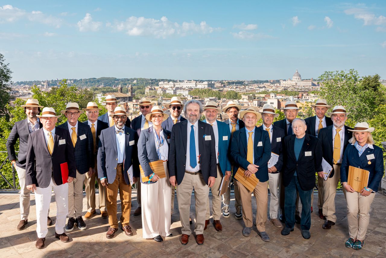 Judges of Anantara Concorso Roma pose on a terrace overlooking Rome, with St Peter&rsquo;s Basilica visible in the distance beneath a clear blue sky.