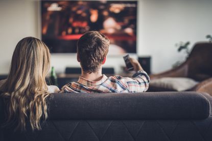 best home theater system - Couple watching TV