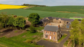 An unmodernised farmhouse surrounded by countryside