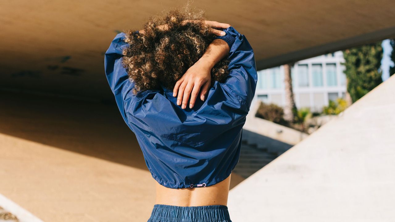 Workout exercises: A woman stretching her arms after a workout