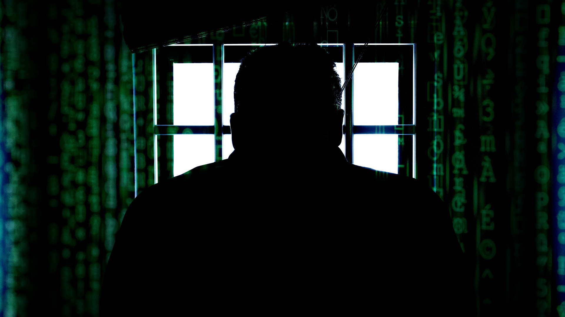 Person in jail, with data scrolling around them