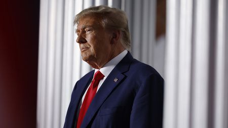 Donald Trump delivers remarks outside the clubhouse at the Trump National Golf Club 