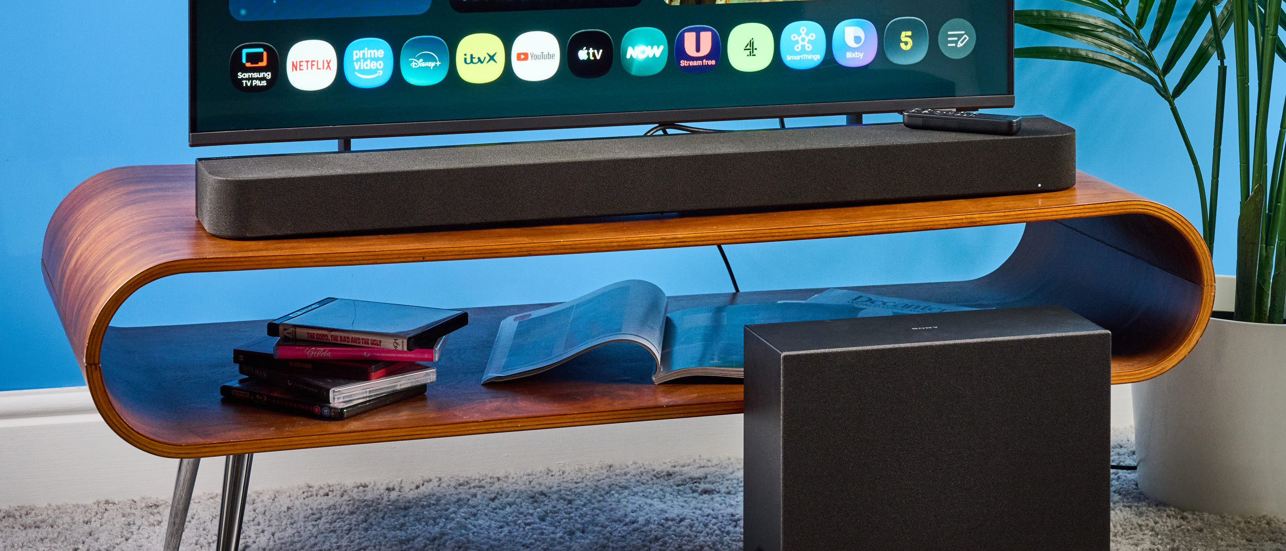 the sony bravia theater bar 7 photographed with the subwoofer with a TV on the tom's guide blue background