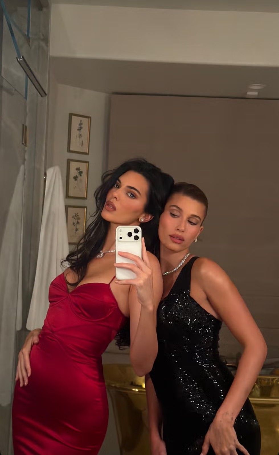 An image of Kendall Jenner and Hailey Bieber wearing matching diamond stud earrings and tennis necklace sets.