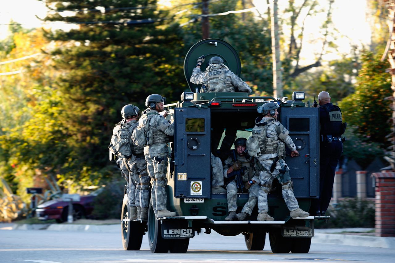 A SWAT team patrols patrols an area of San Bernardino.