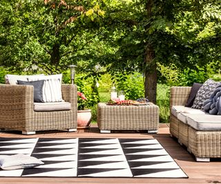 Comfy garden furniture and geometrical rug on a gardenterrace