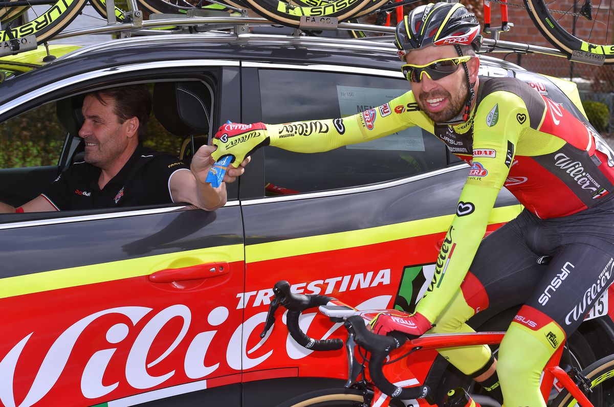 Wilier boss Luca Scinto handing out bidons from the team car