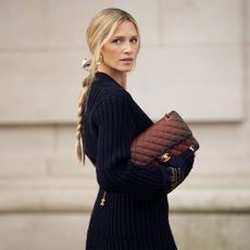 a blonde woman carrying a chanel bag