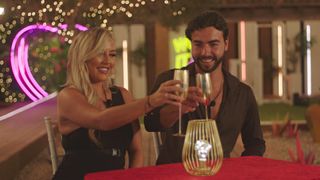 Sammy and Jess toasting their gold champagne flutes in the Love Island 2023 villa during the 'Graftie' awards