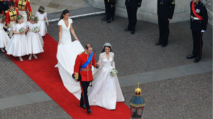 Their Royal Highnesses Prince William, Duke of Cambridge and Catherine, Duchess of Cambridge are followed by Maid of Honour Pippa Middleton, their page boys and bridesmaids and their best man Prince Harry as they prepare to begin their journey by carriage procession to Buckingham Palace following their marriage at Westminster Abbey on April 29, 2011 in London, England.