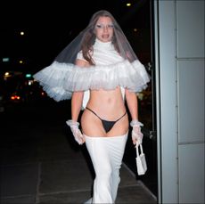 julia fox in a black thong and white veil and wedding dress