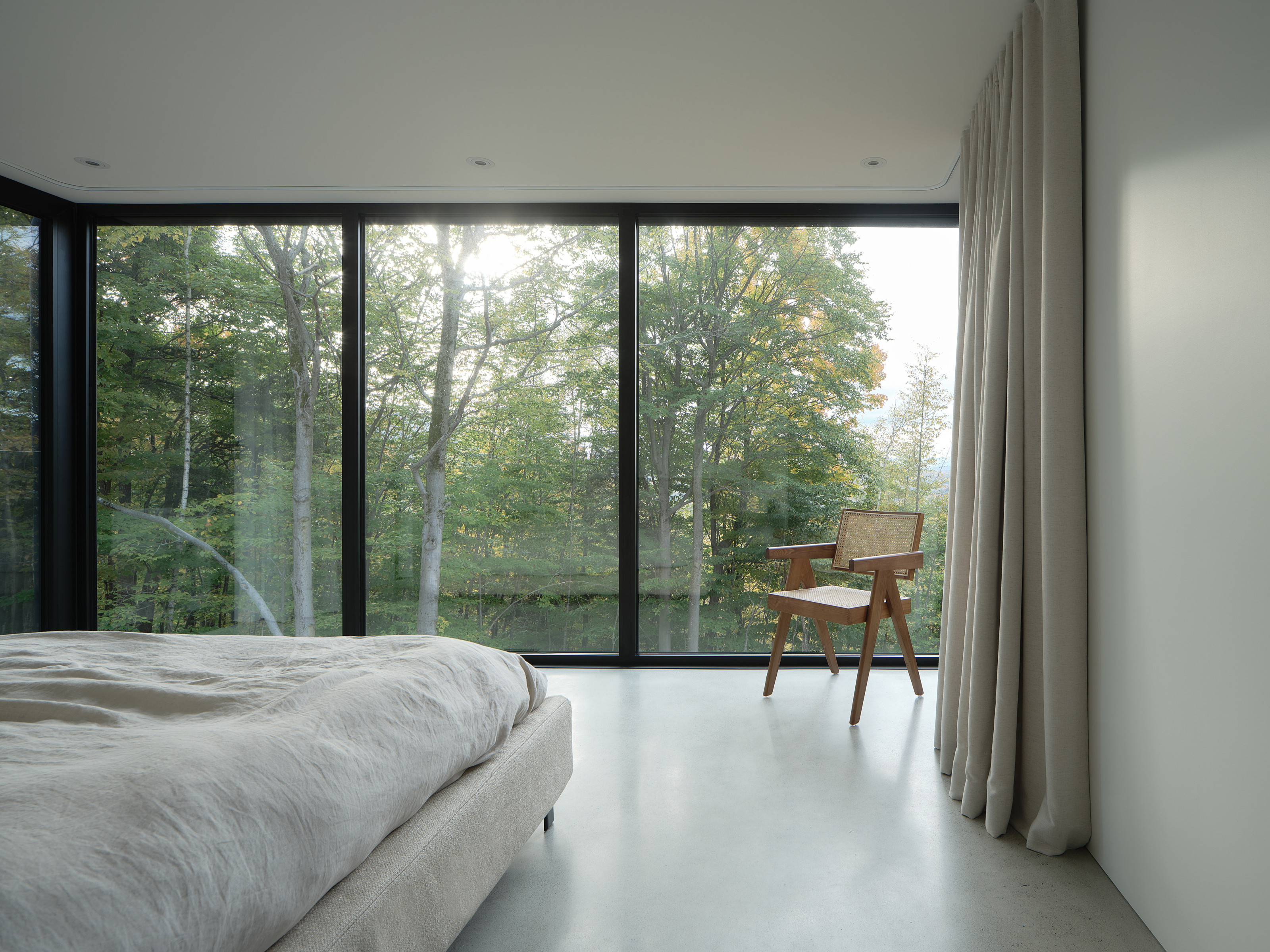 The primary bedroom appears to reach out into the canopy