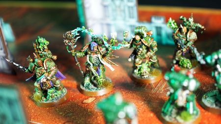 Plague Marines in a line on an orange battlefield