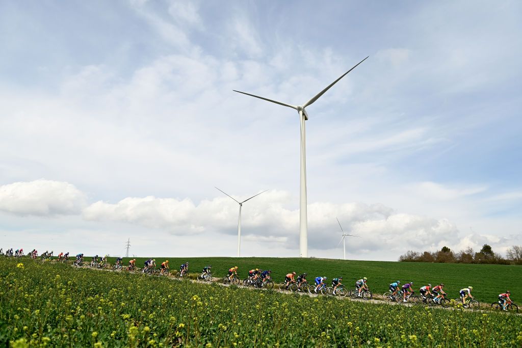 MOLINS DE REI SPAIN MARCH 25 A general view of the peloton passing through a wind farm during the 102nd Volta Ciclista a Catalunya 2023 Stage 6 a 1741km stage from Martorell to Molins de Rei UCIWT on March 25 2023 in Molins de Rey Spain Photo by David RamosGetty Images