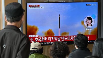 South Koreans watch news broadcast
