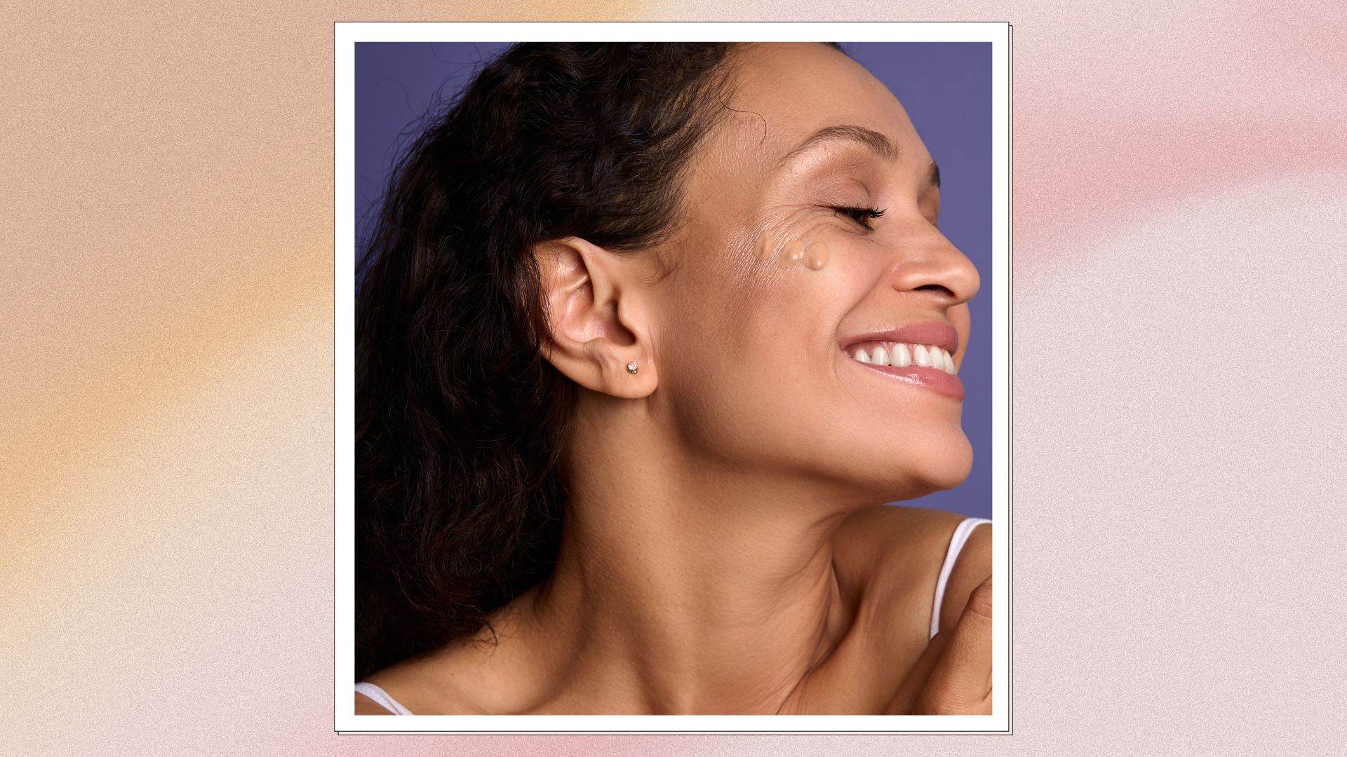 A pink and orange frame containing an image of a smiling woman with a few blobs of tinted sunscreen on her face