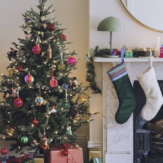 christmas tree with marble fireplace and two stockings