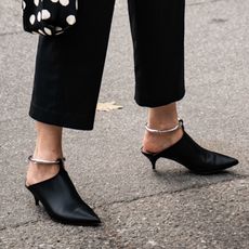 woman wearing black kitten heel mules