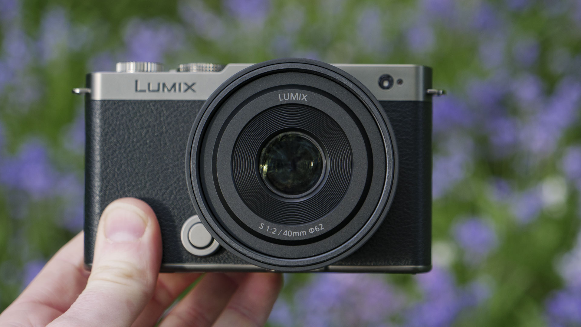 The Panasonic Lumix S 40mm F2 lens attached to a 'titanium' version of the Lumix S9, with natural bluebell backdrop