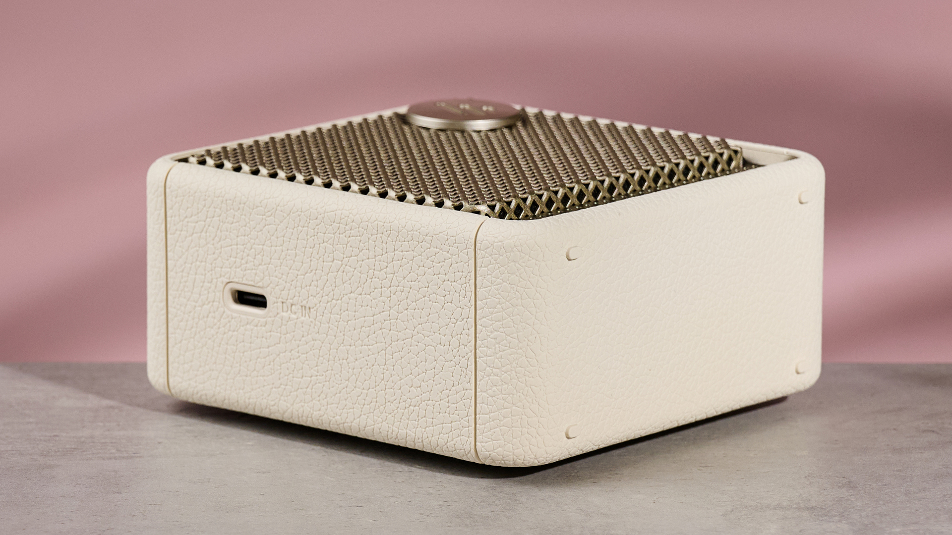 Edifier ES20 laying flat on table, against pink background
