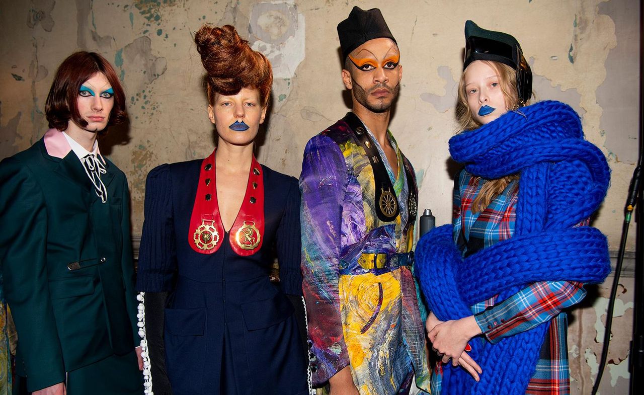 Group of models posing in colourful clothing &amp; dramatic make up