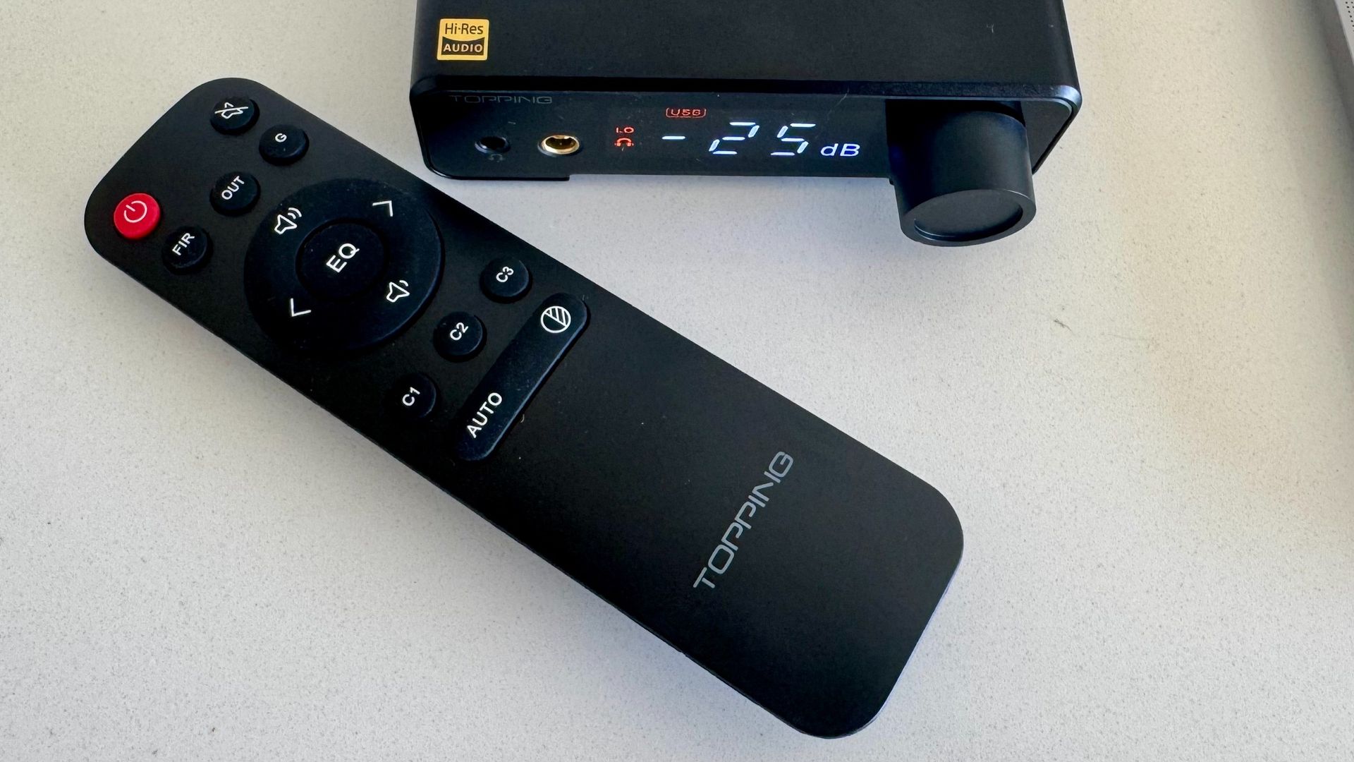 Topping DX1 II DAC remote control on a white surface