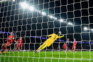 Liverpool goalkeeper Alisson Becker makes a diving save during the Champions League last 16 first leg match against PSG at the Parc des Princes in Paris on 5 March, 2025