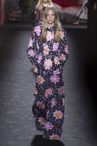 a model wears a two piece floral logo chanel suit blake lively would later wear on a chanel spring 2024 runway