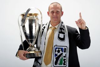 Colorado Rapids coach Gary Smith poses with the MLS Cup in November 2010.