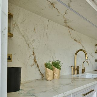 David Gandy kitchen statement stoned marble on walls